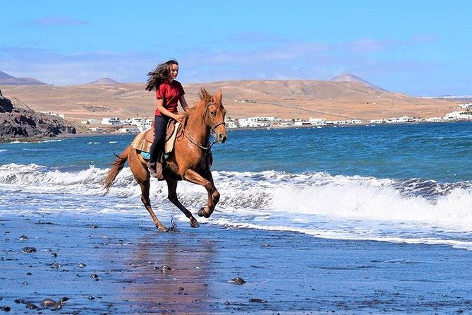 horseback-riding-in-the-sunset-of-famara-beach-lanzarote-spain