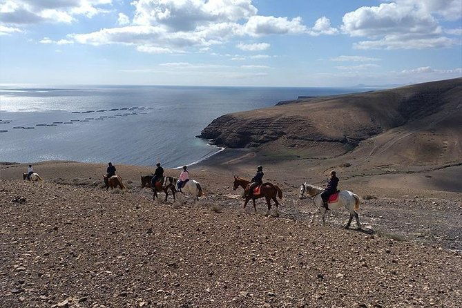 horseback-riding-in-the-sunset-of-famara-beach-lanzarote-spain