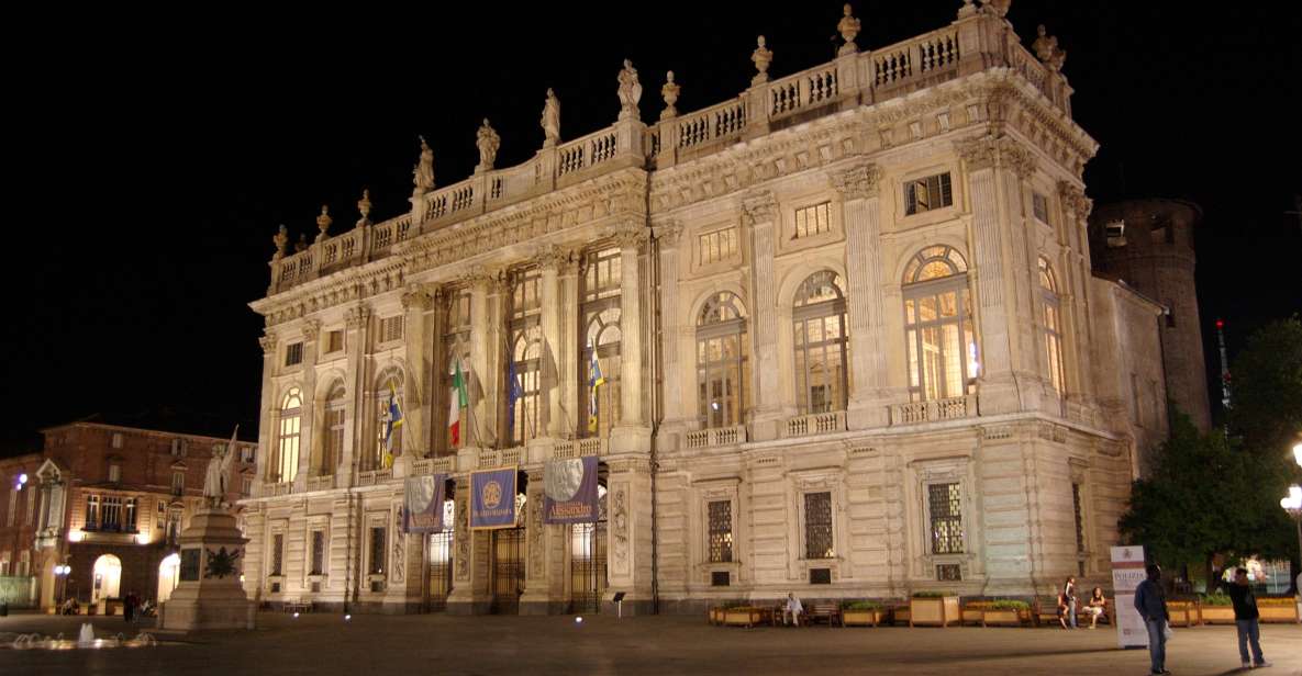 Piazza Castello in Turin at dusk, showcasing the illuminated Royal Palace and Palazzo Madama.
