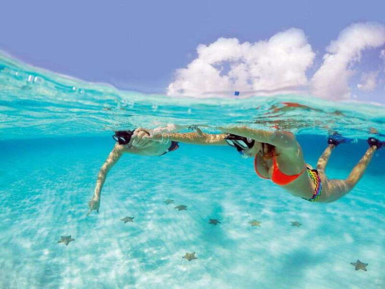 snorkeling-in-cozumel-waters-in-a-transparent-boat-beers
