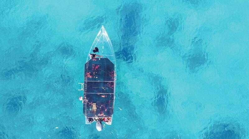 snorkeling-in-cozumel-waters-in-a-transparent-boat-beers