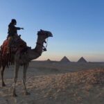 sunset at Giza pyramids by camels - The Camel Ride: A Scenic Highlight