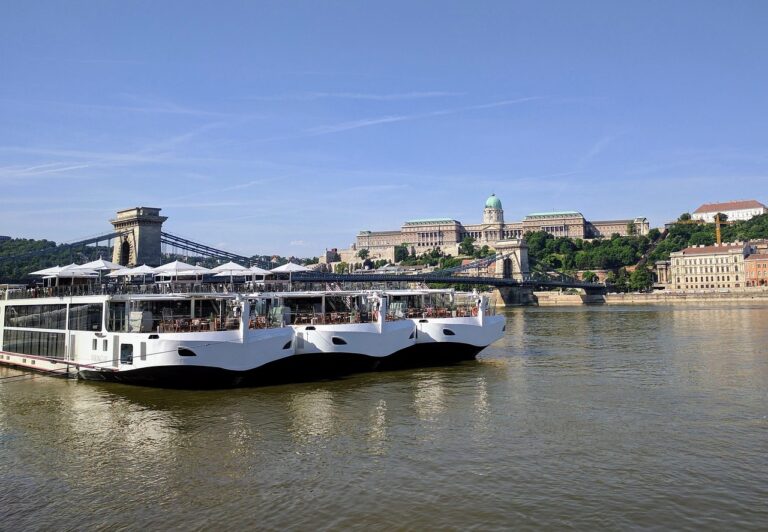 Sightseeing cruise boat sailing on the Danube River in Budapest with views of historic buildings