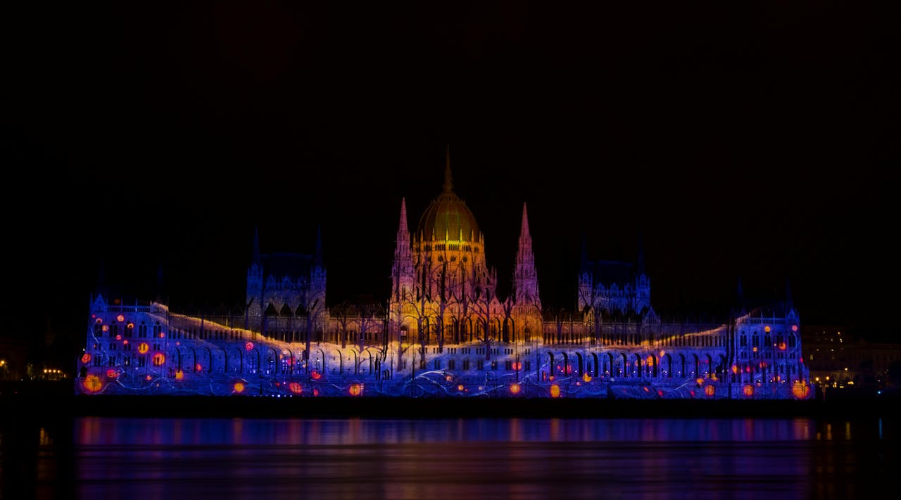 Budapest cityscape illuminated at night viewed from the Danube River
