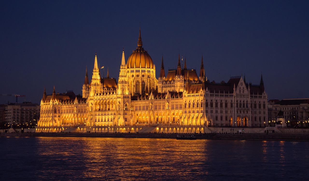 Buda Castle and Castle Hill illuminated at night as seen from the Danube River
