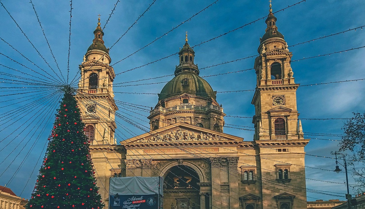 The main nave of St Stephens Basilica in Budapest with rows of pews and the main altar