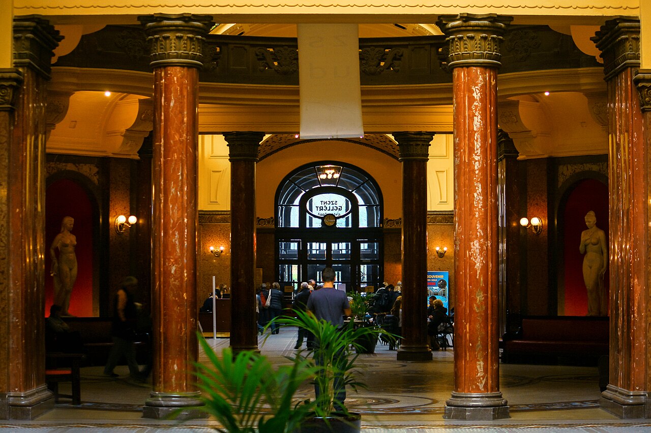 The interior pool hall at Gellért Bath with ornamental columns and mosaic tiles