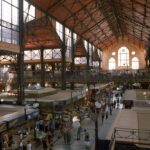 Interior of Budapest Great Market Hall with vendors and shoppers browsing