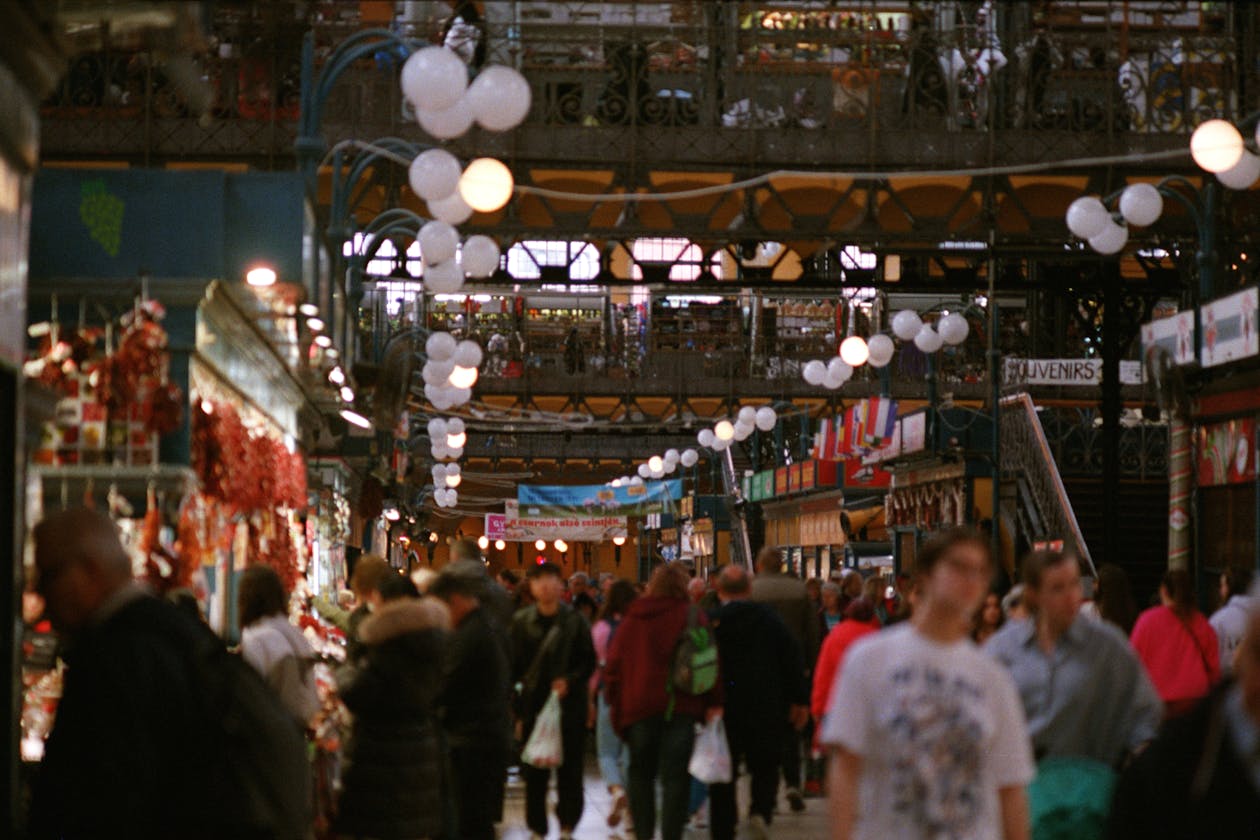 Colorful produce stalls and shoppers inside Budapest Central Market Hall