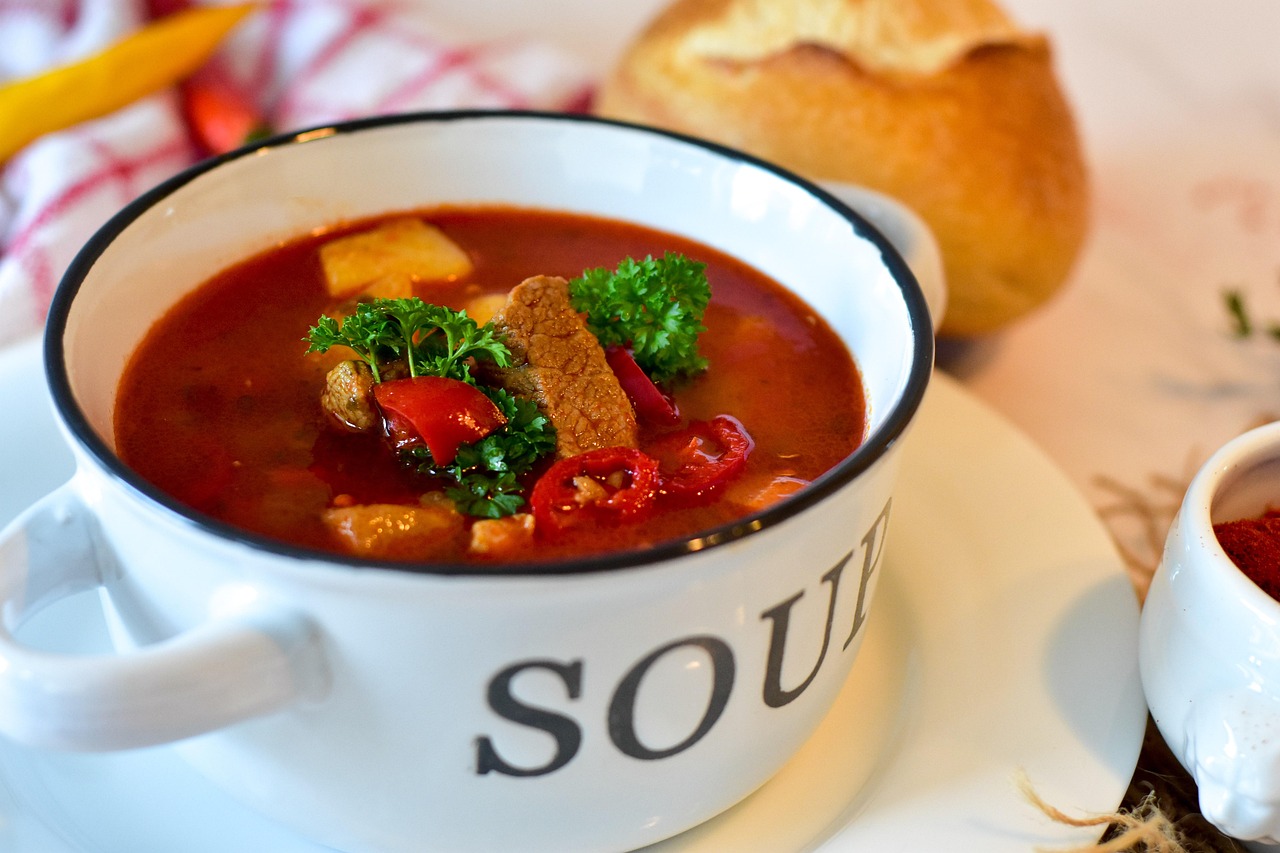 A bowl of traditional Hungarian goulash soup with paprika, meat and vegetables