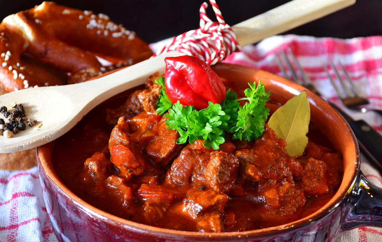 Hungarian beef goulash served on a plate with red paprika