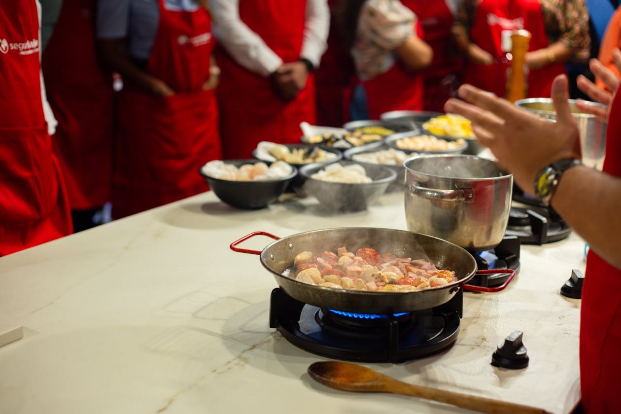 People learning to cook together in a hands-on cooking class