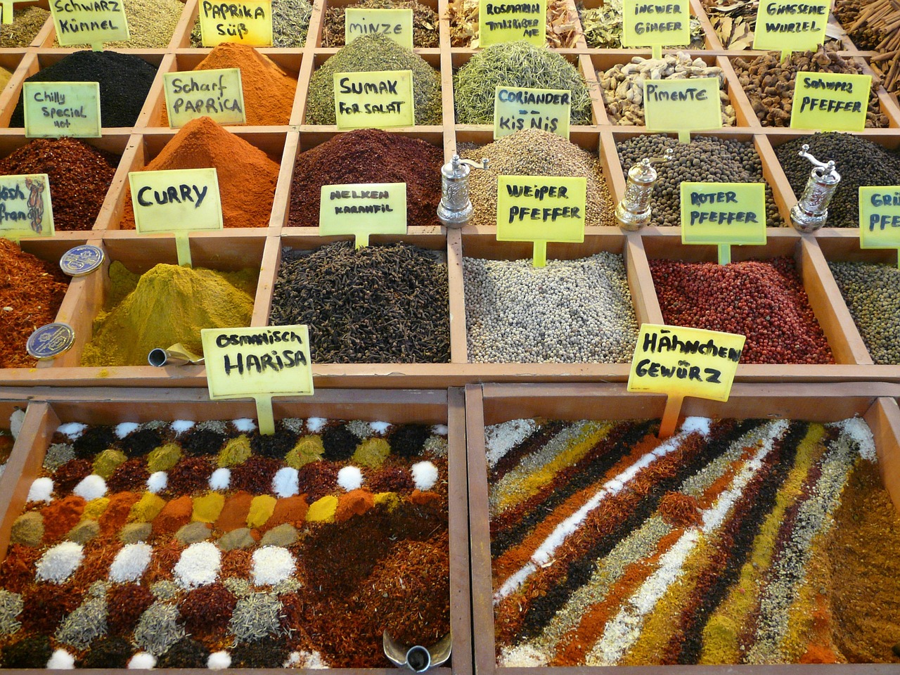 A colorful display of spices including paprika at a market stall