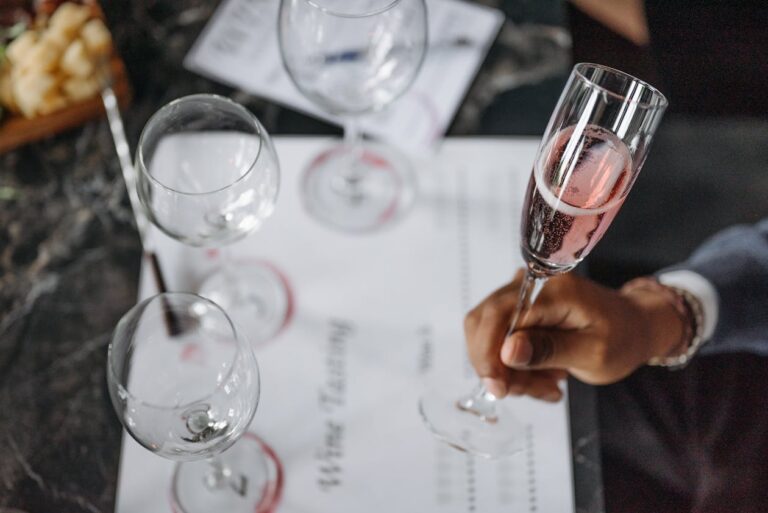 Close-up of wine tasting glasses with red and white wine being poured