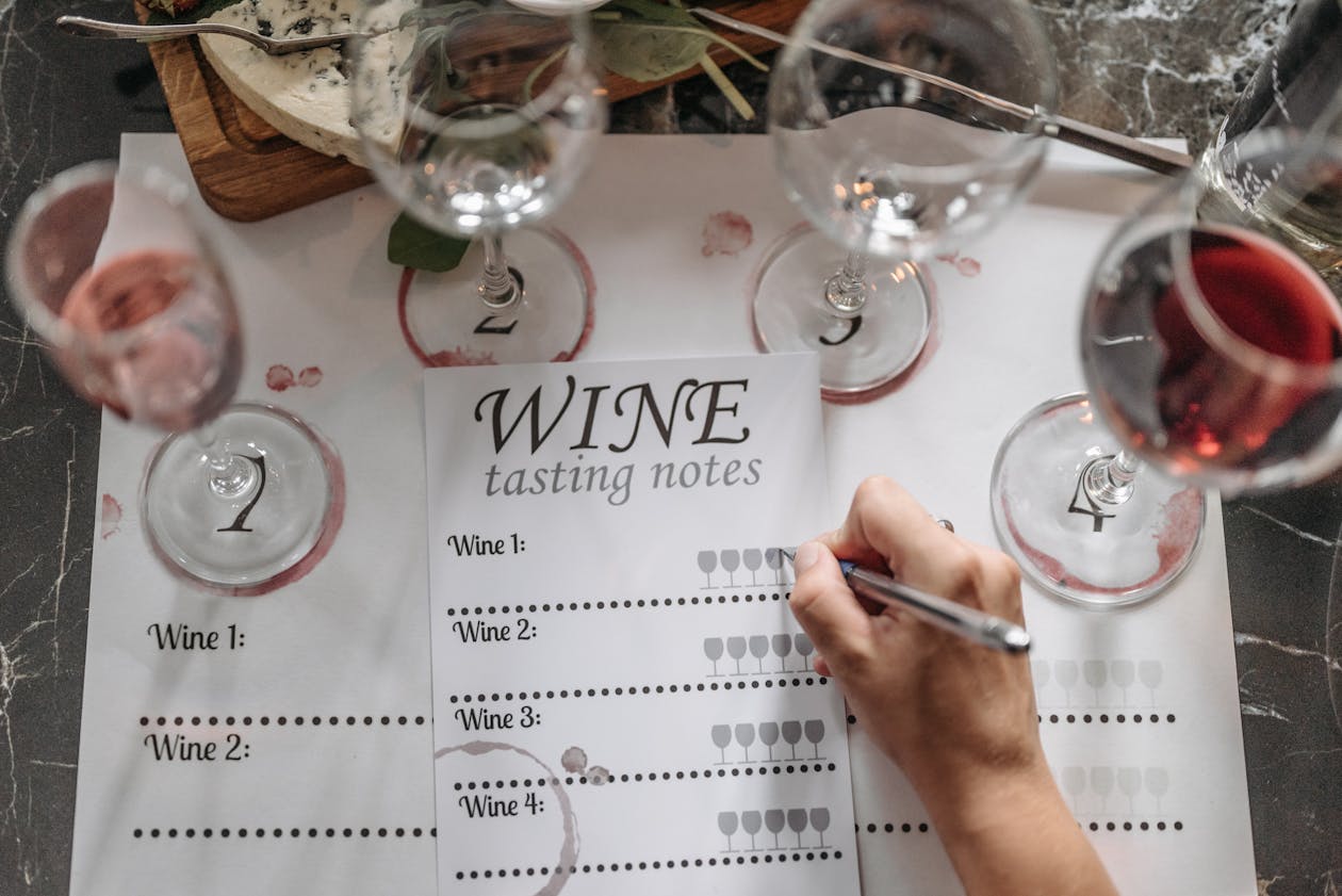 Overhead view of wine glasses and tasting notes on a table