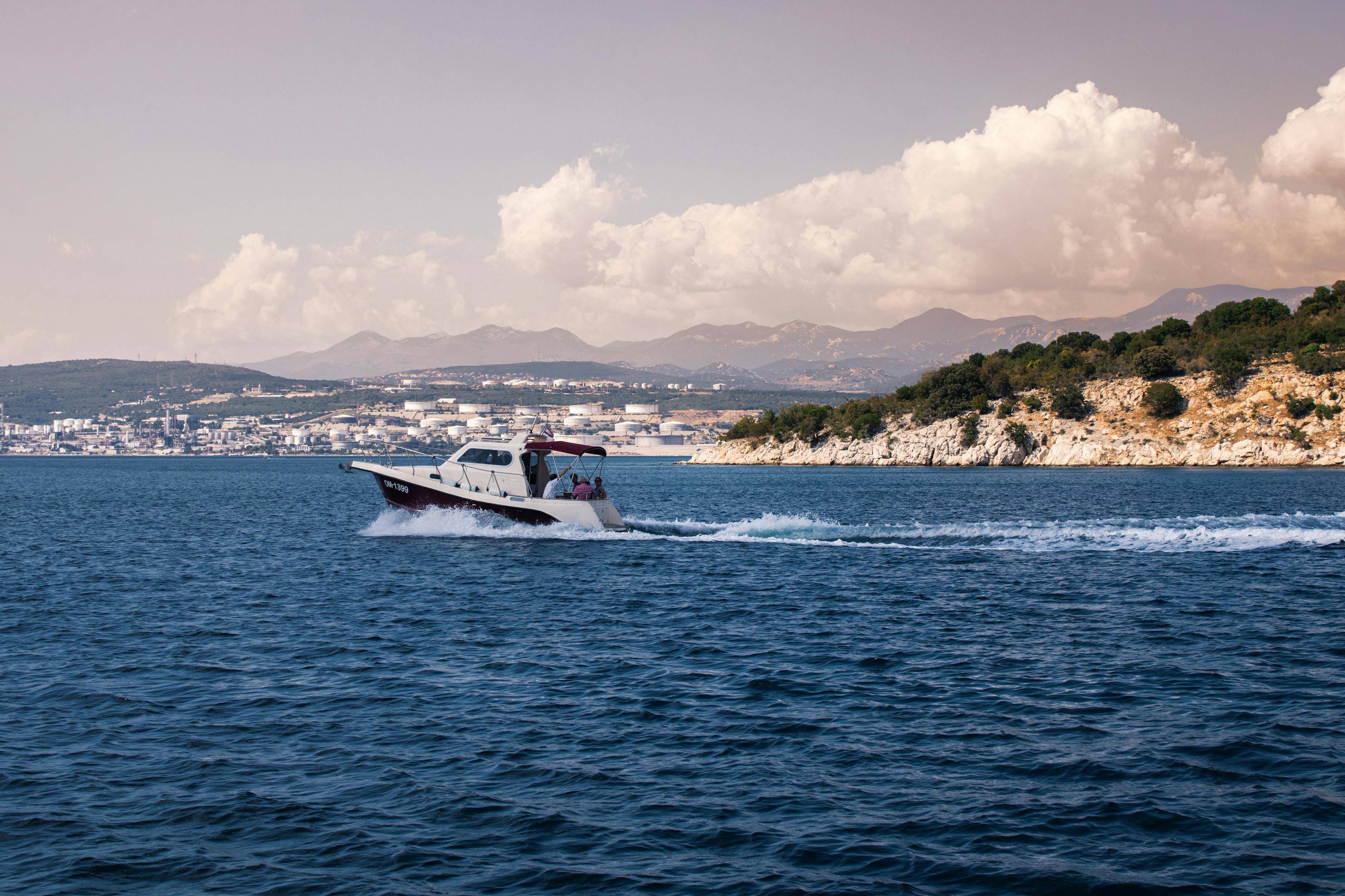 A motorboat racing on the Adriatic Sea near Croatia's rugged coastline