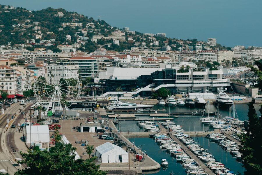Aerial shot of Cannes harbor with yachts and cityscape on the French Riviera