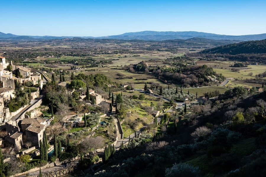 Aerial view of Gordes village surrounded by lush Provence landscapes