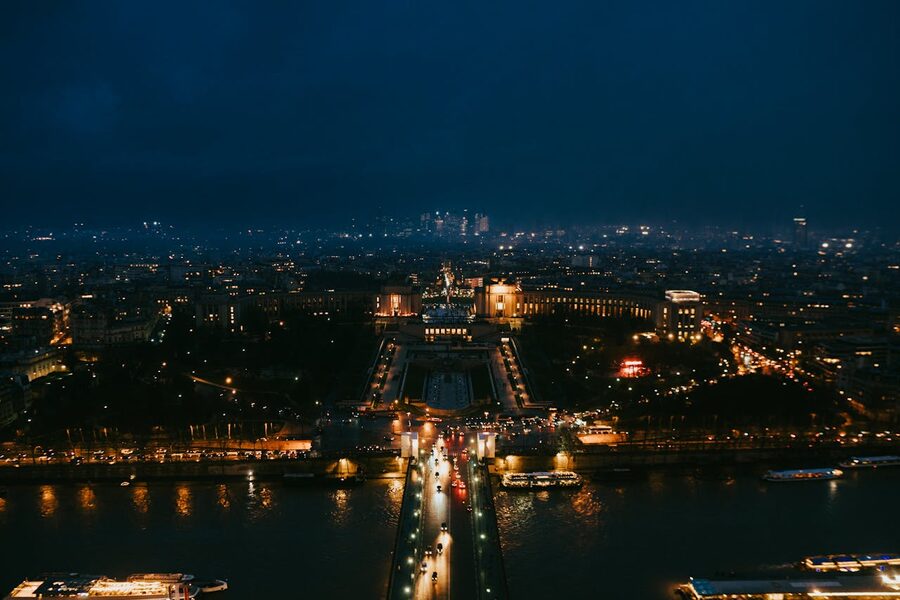 Aerial nighttime view of Paris highlighting iconic landmarks