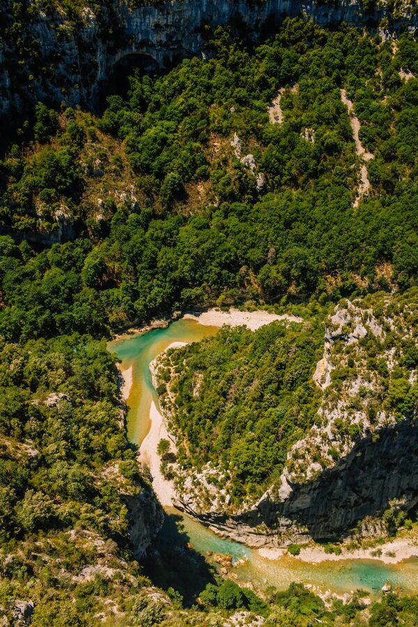Aerial shot of the Verdon Gorge with clear green water and lush canyon walls