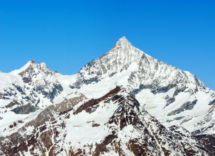 Alps snow-covered peaks with clear blue sky