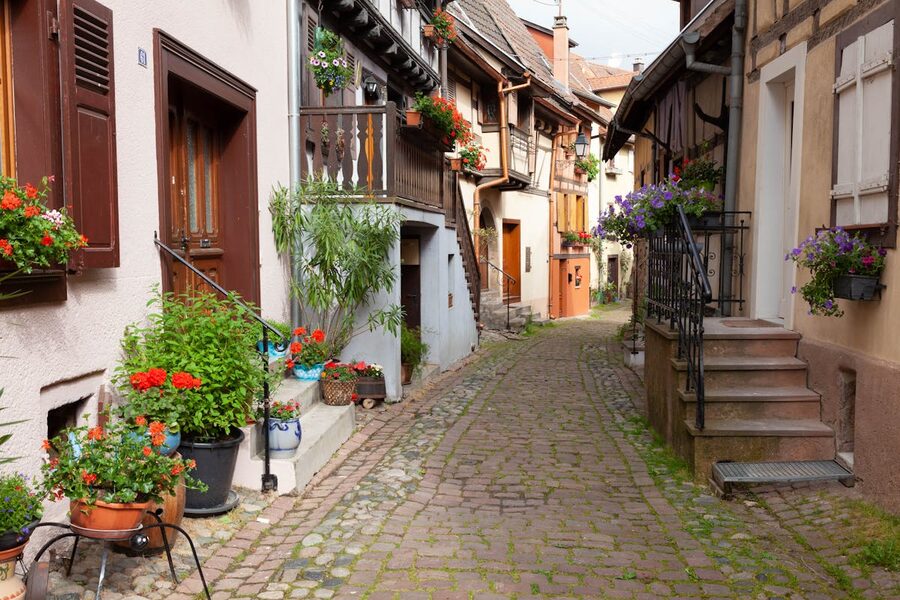 Medieval village street in Alsace with half-timbered houses