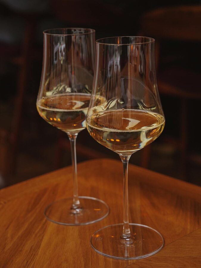 Alsace wine tasting glass with vineyard backdrop