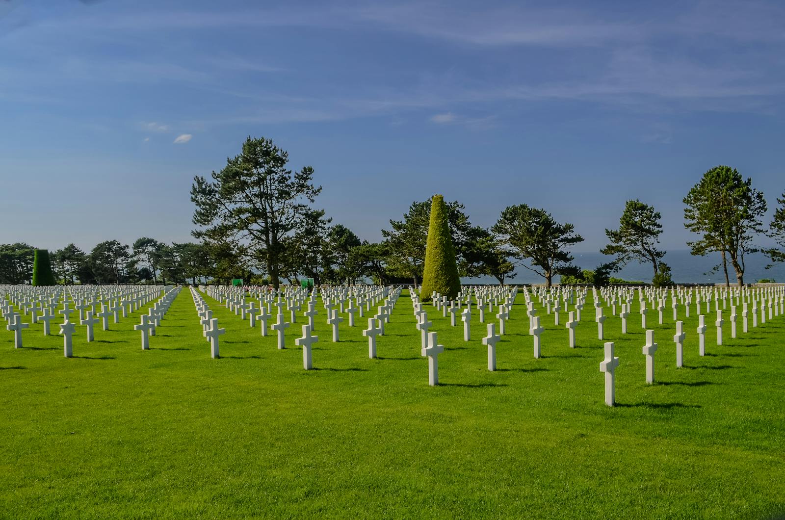Wide view of the American Cemetery in Normandy with rows of crosses honoring WWII soldiers