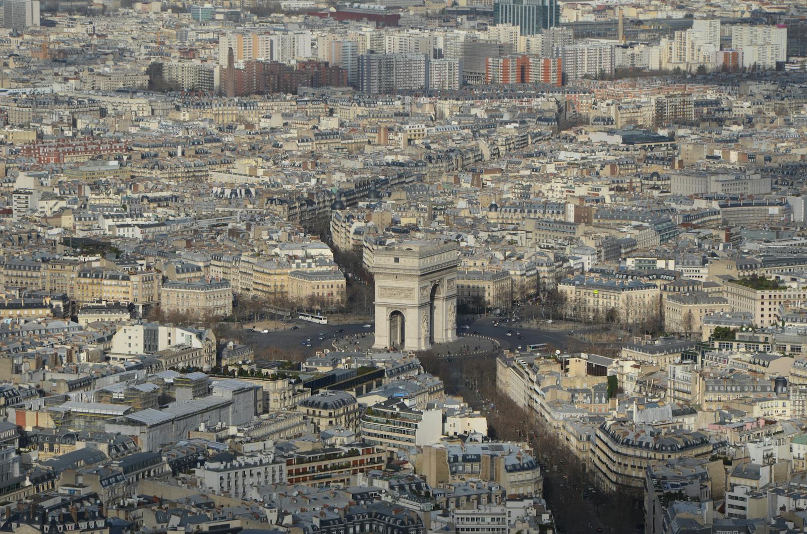 Aerial view of the Arc de Triomphe surrounded by twelve avenues in Paris cityscape