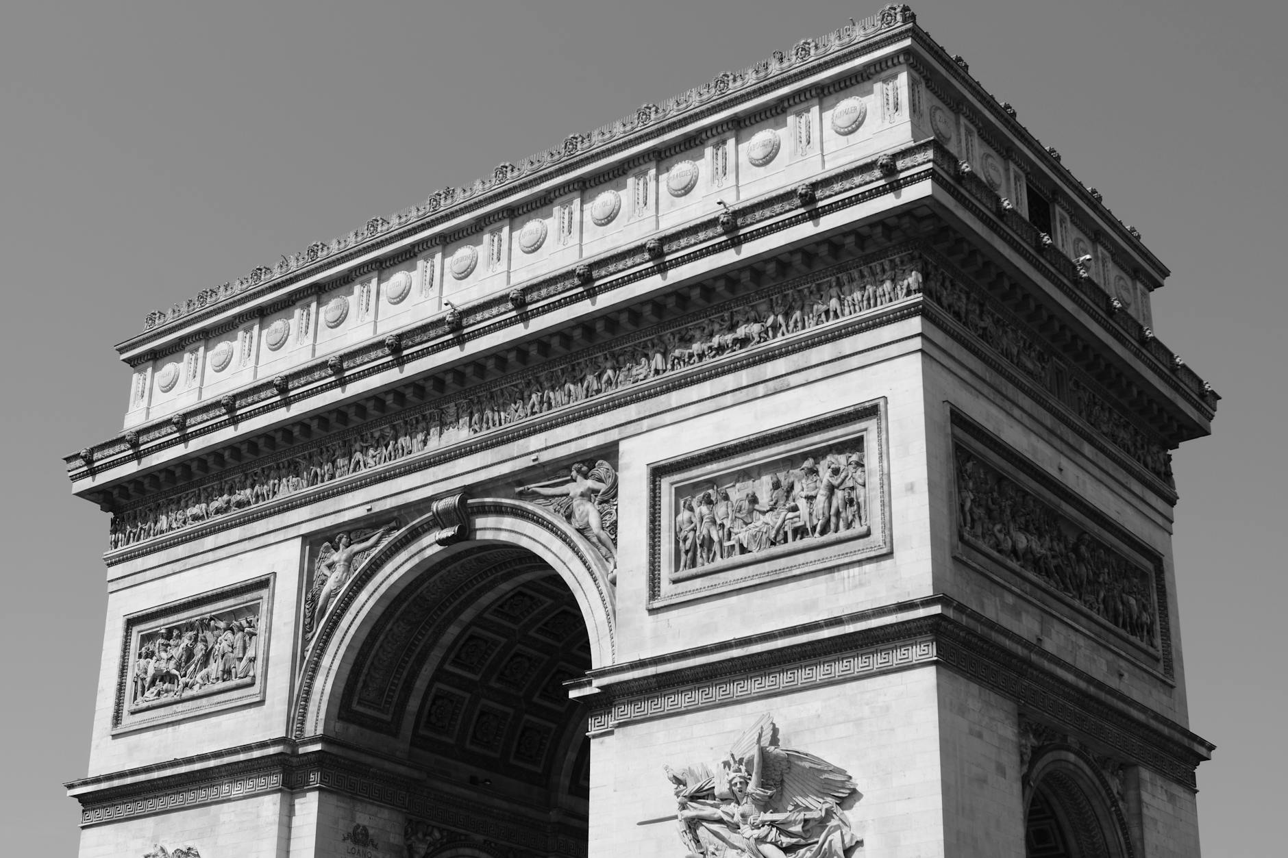 An iconic black and white photograph of the Arc de Triomphe in Paris