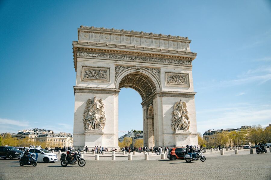 The iconic Arc de Triomphe under a clear blue sky in Paris France