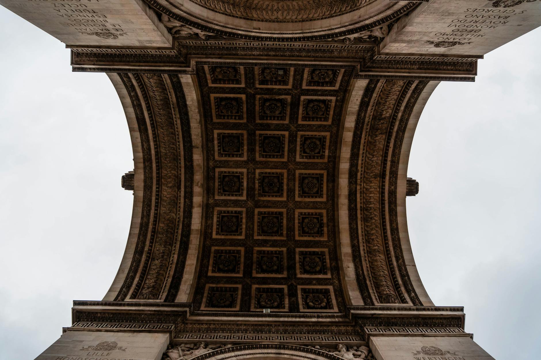 The intricate ceiling of the Arc de Triomphe showing historic artistic detail