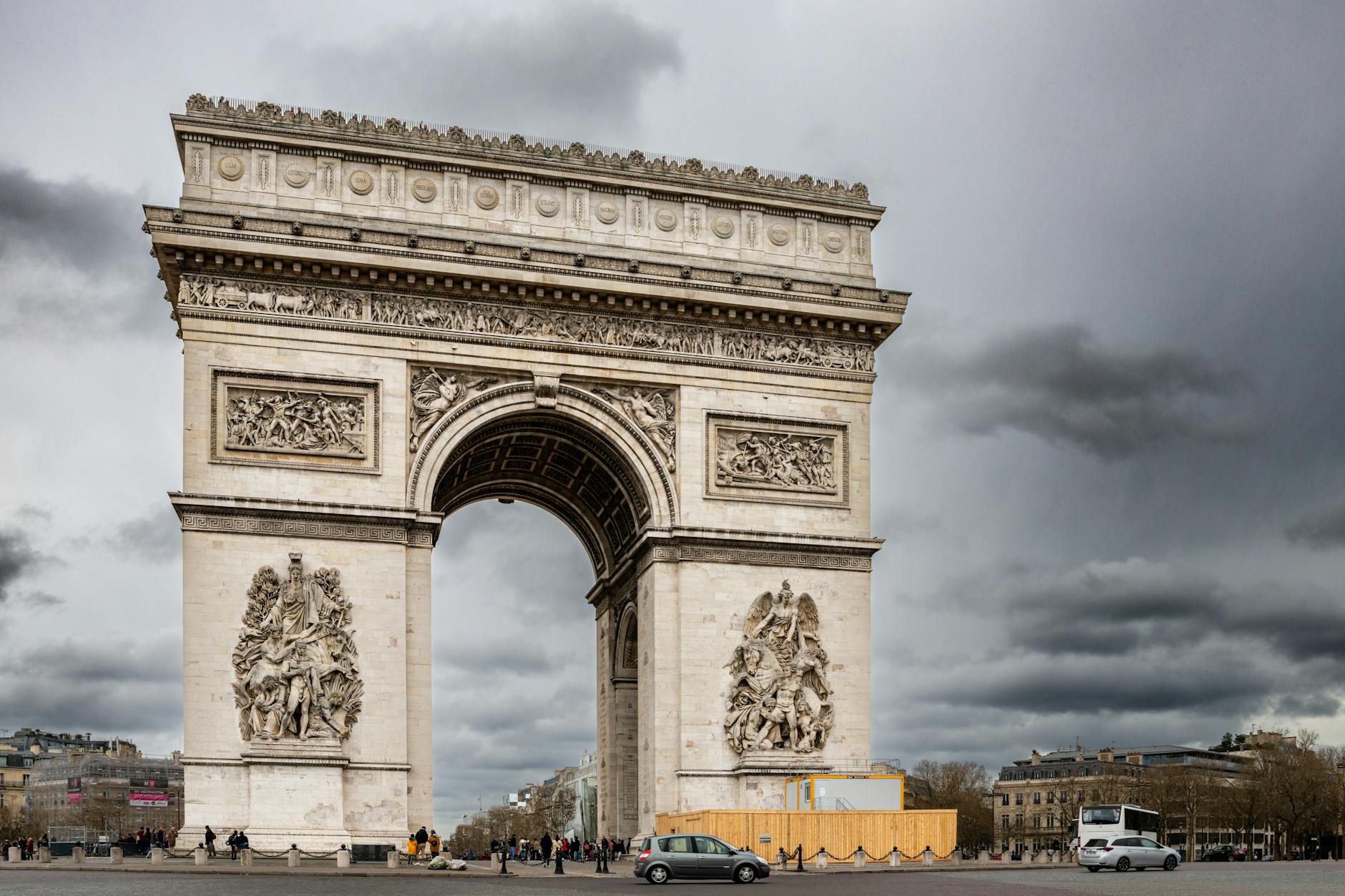 The Arc de Triomphe on a cloudy day showing its historic architecture