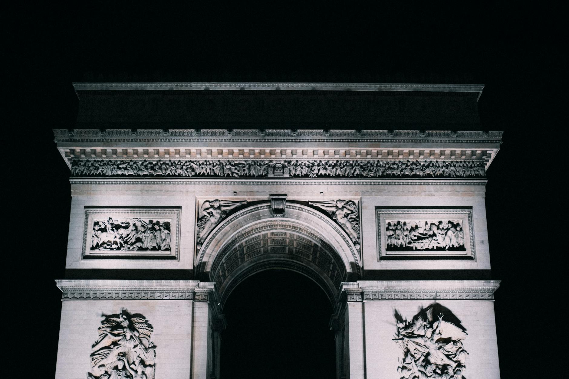 The Arc de Triomphe illuminated against a Paris night sky