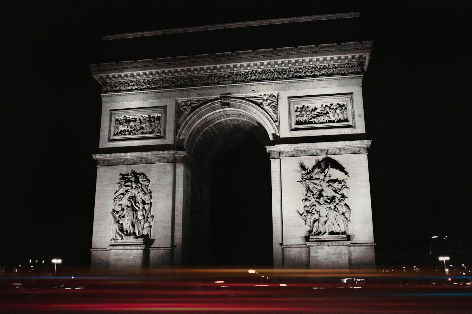 Stunning night view of the Arc de Triomphe illuminated with car light trails
