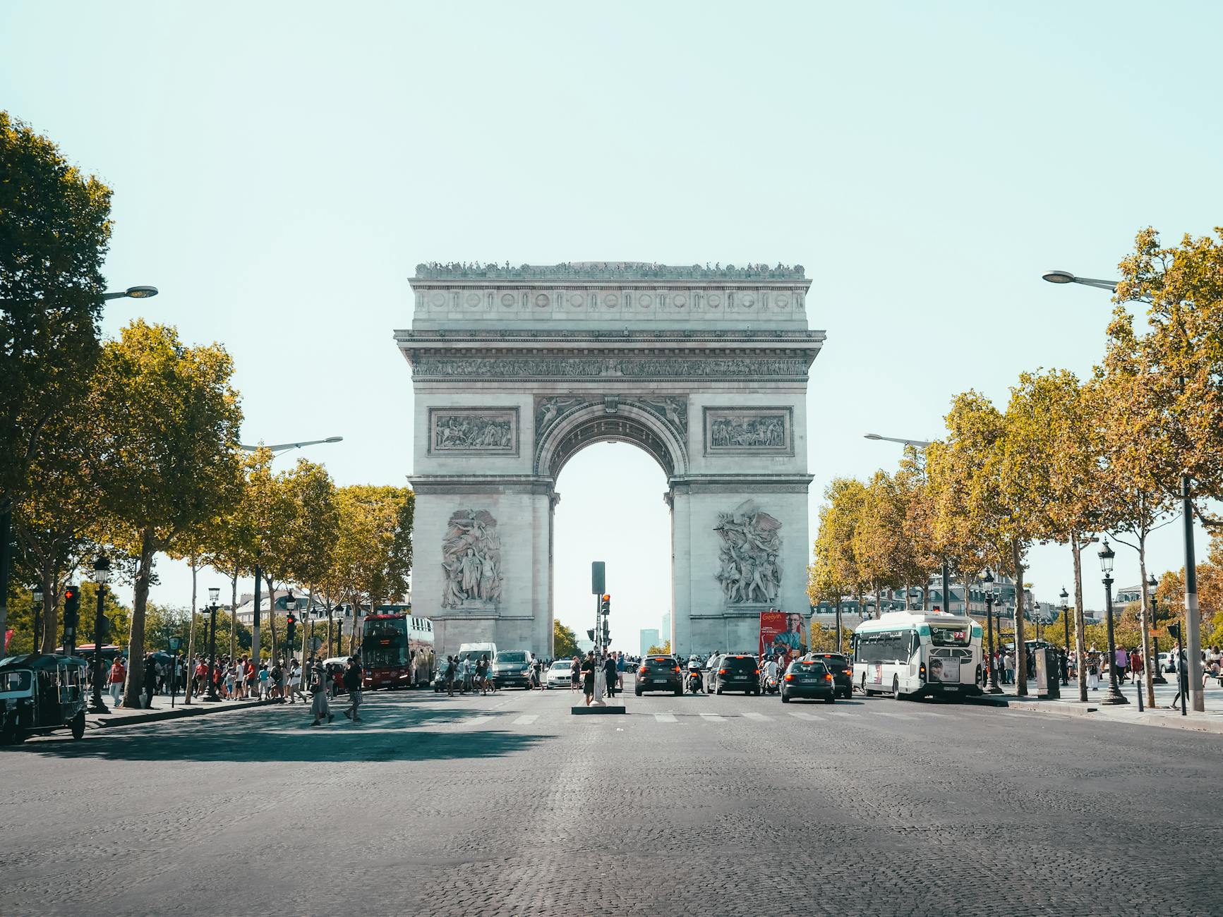 View of Arc de Triomphe with street traffic during the day