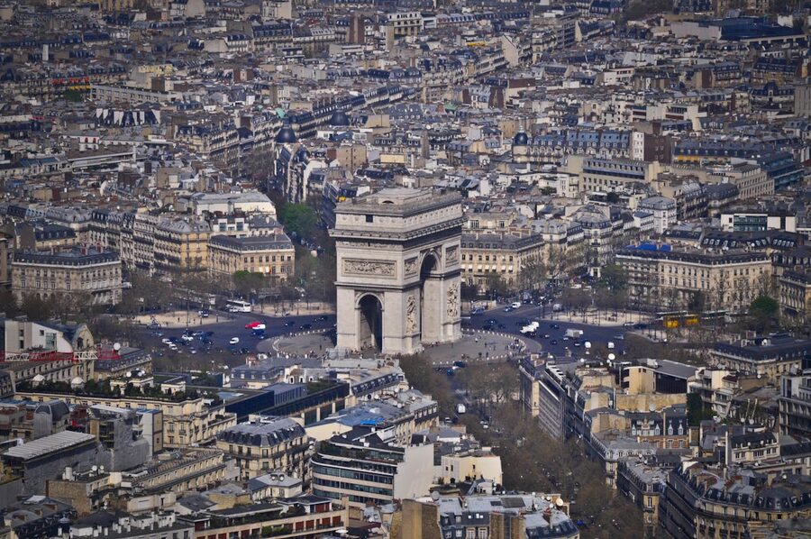 Aerial view of Arc de Triomphe surrounded by Parisian cityscape