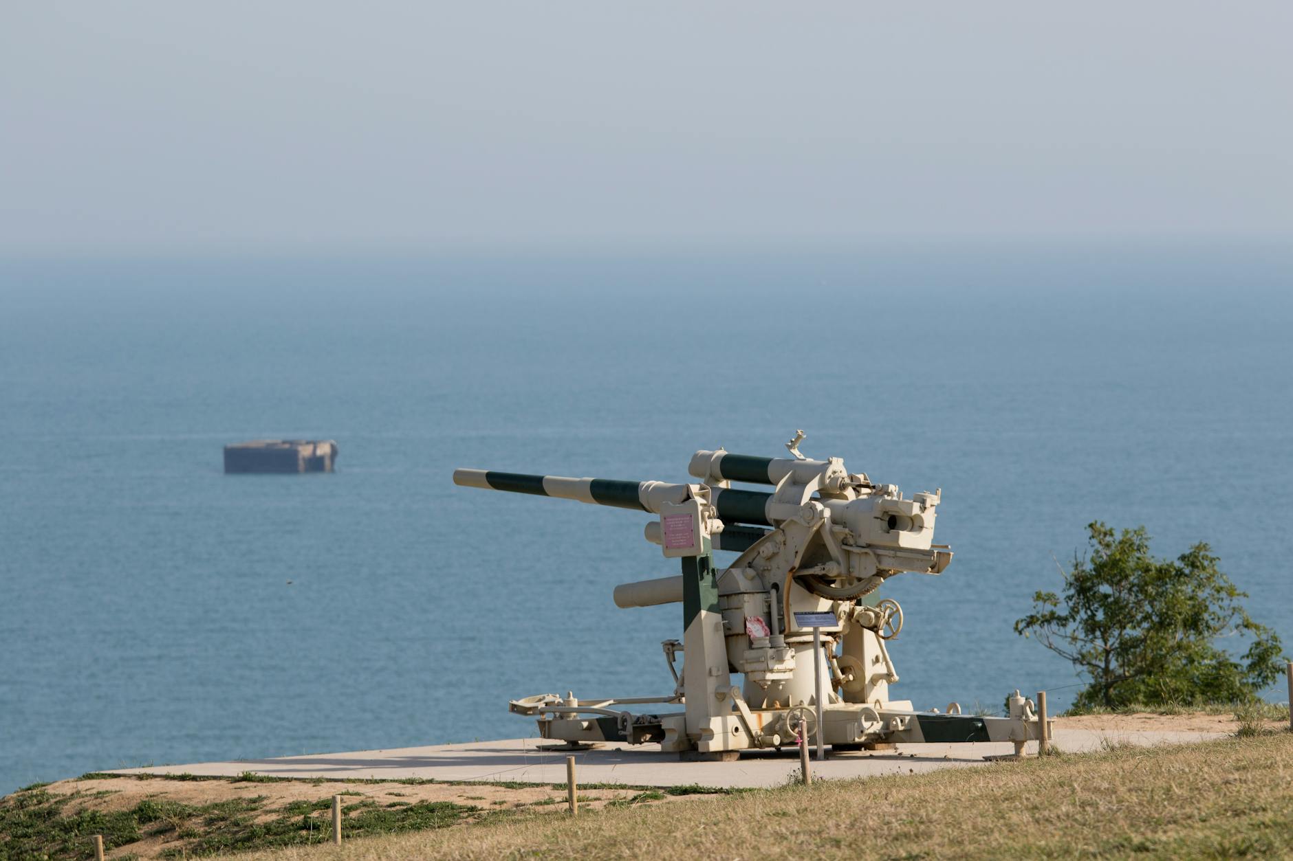 Historic cannon overlooking the sea at Arromanches-les-Bains Normandy with the bay in the distance