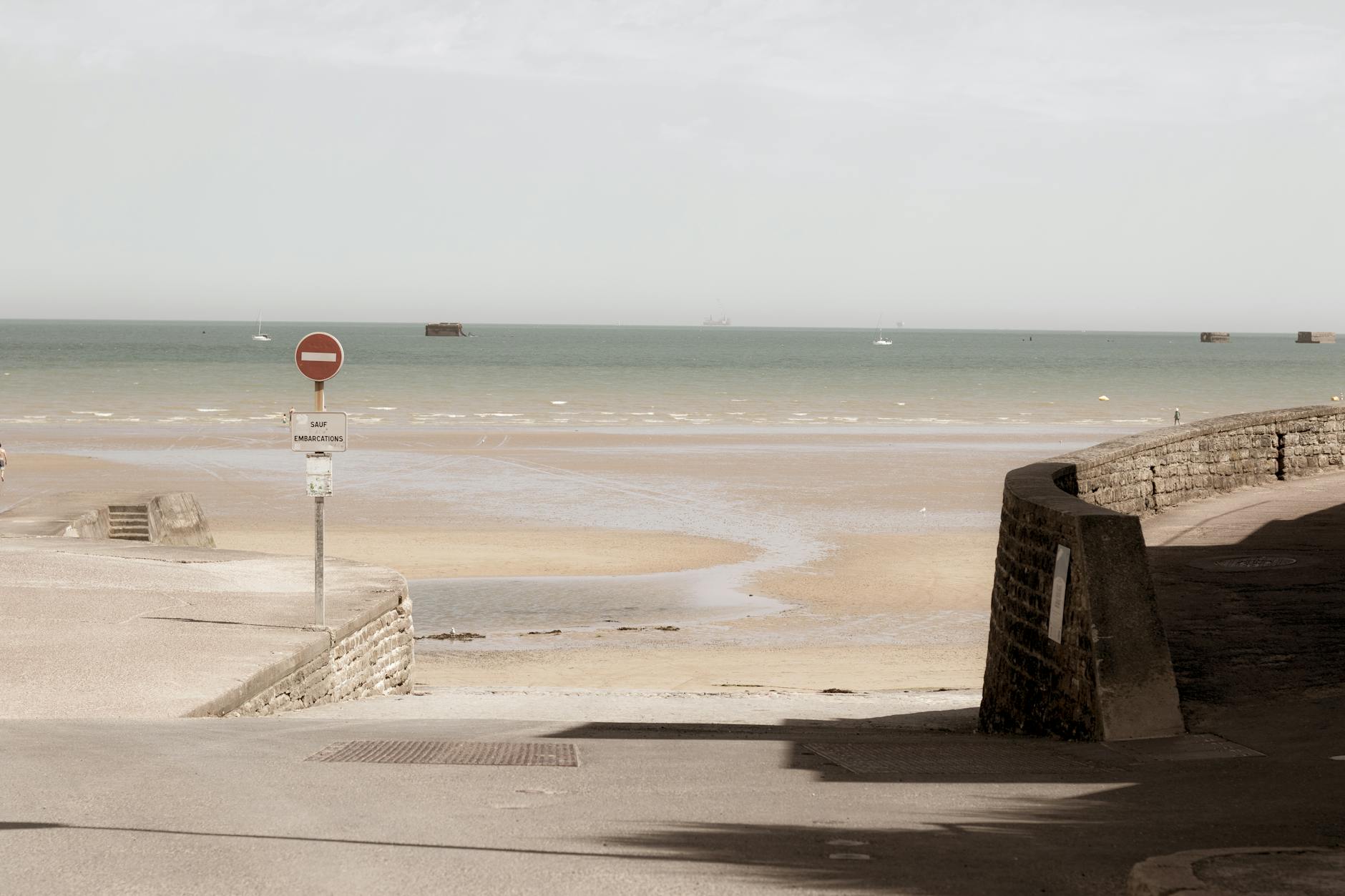 View of Arromanches-les-Bains harbour in Normandy with historic harbour elements