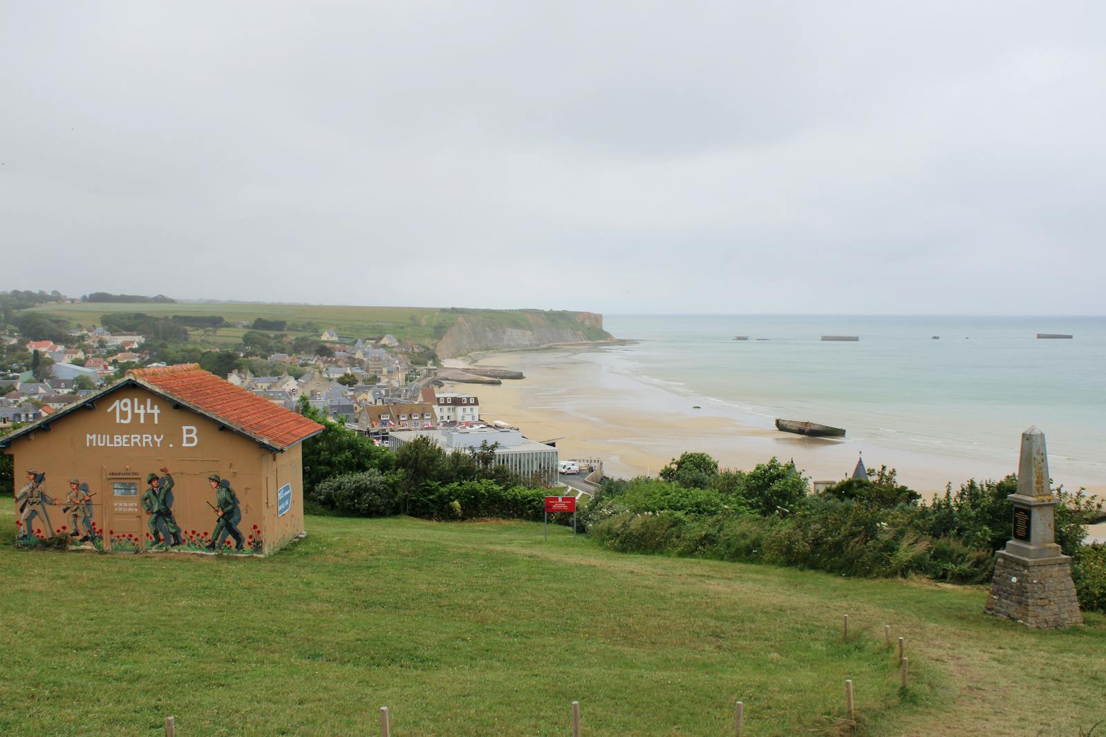 Historic Arromanches-les-Bains coastline featuring Mulberry B remains from WWII