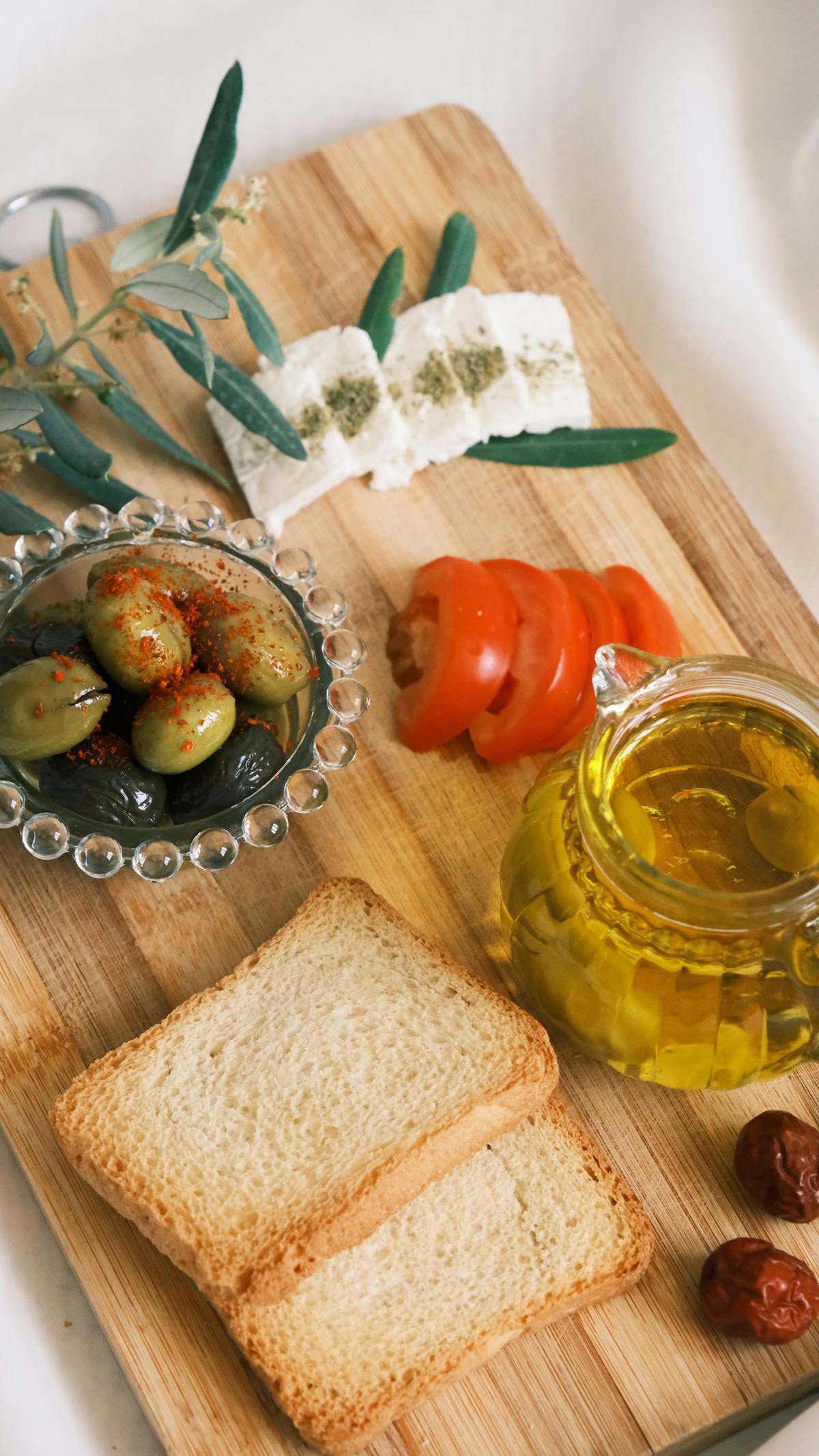 Mediterranean appetizers including olives, feta cheese, and fresh herbs