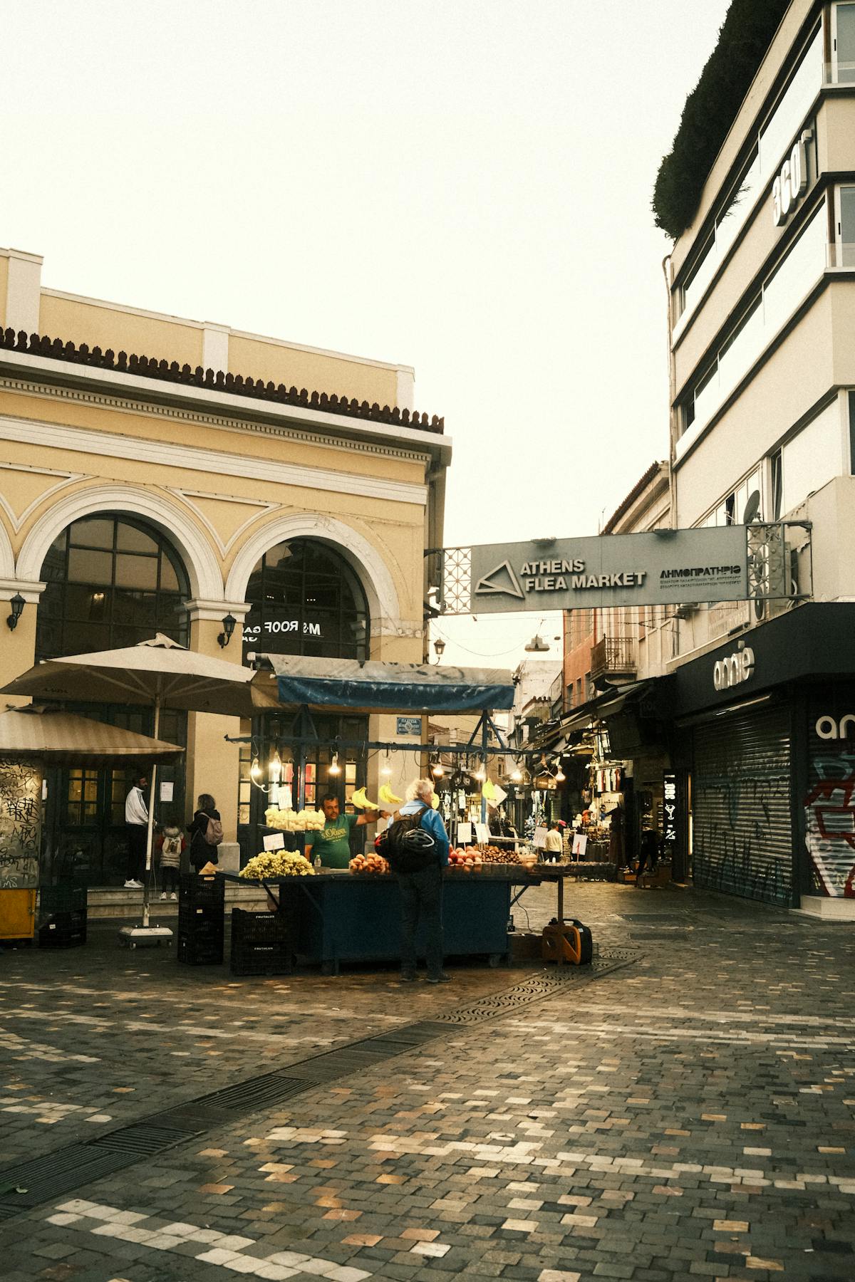 Athens market with vendors selling goods and shoppers exploring