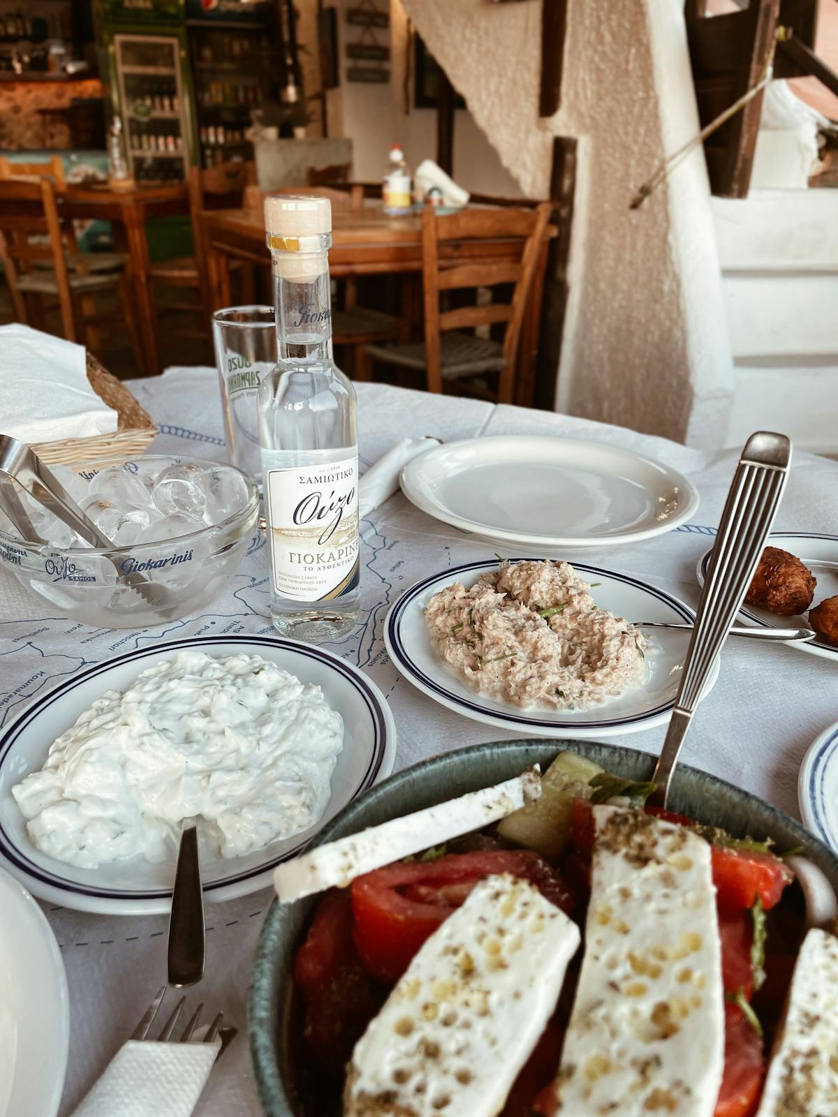 Traditional Greek meal with authentic dishes and ouzo