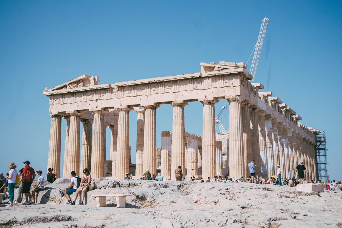 Tourists visiting the Parthenon at the Acropolis on a sunny day