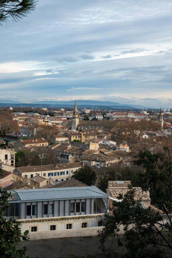 View of Avignon rooftops and church spires under blue sky
