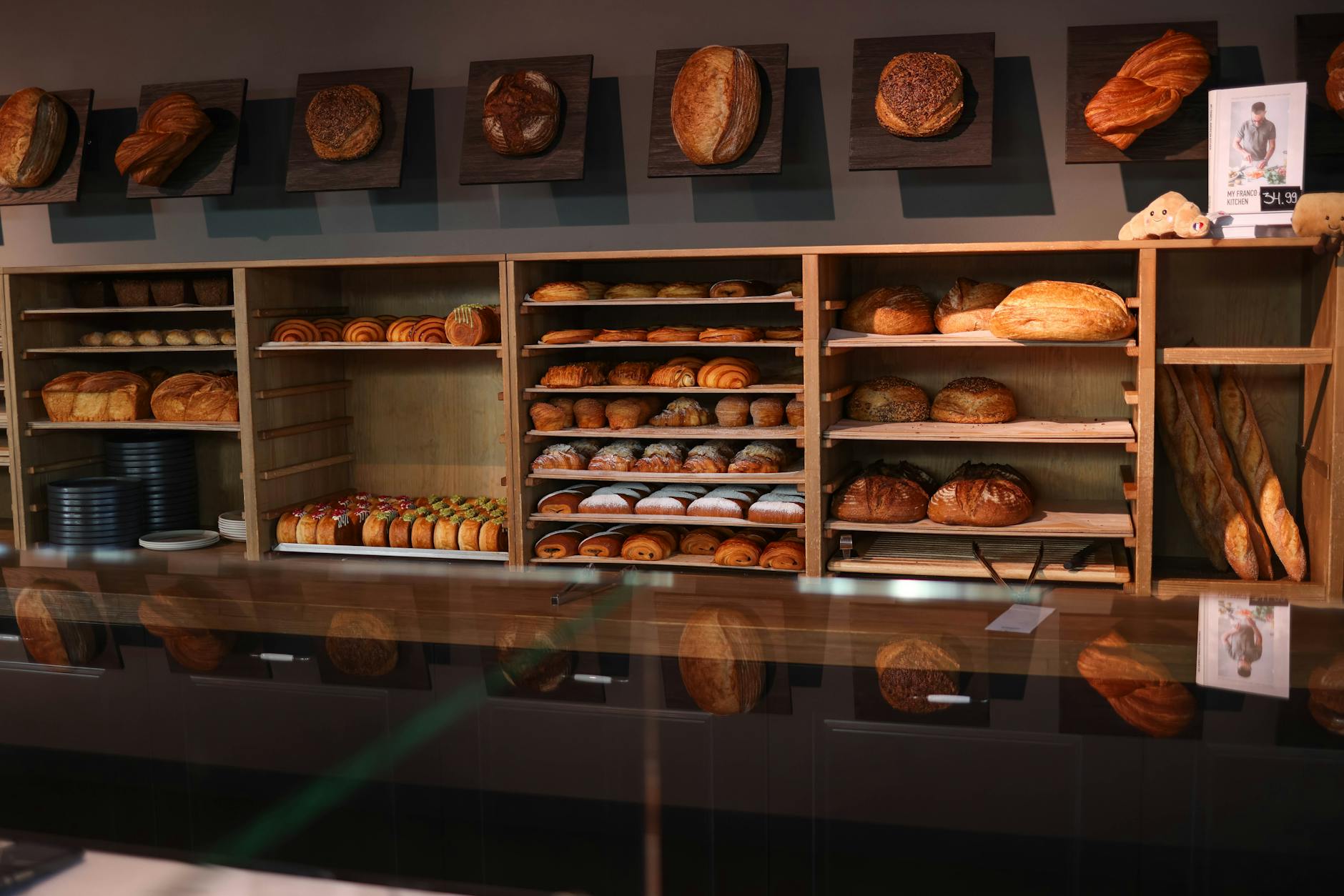 Cosy bakery showcasing fresh bread and pastries on wooden shelves