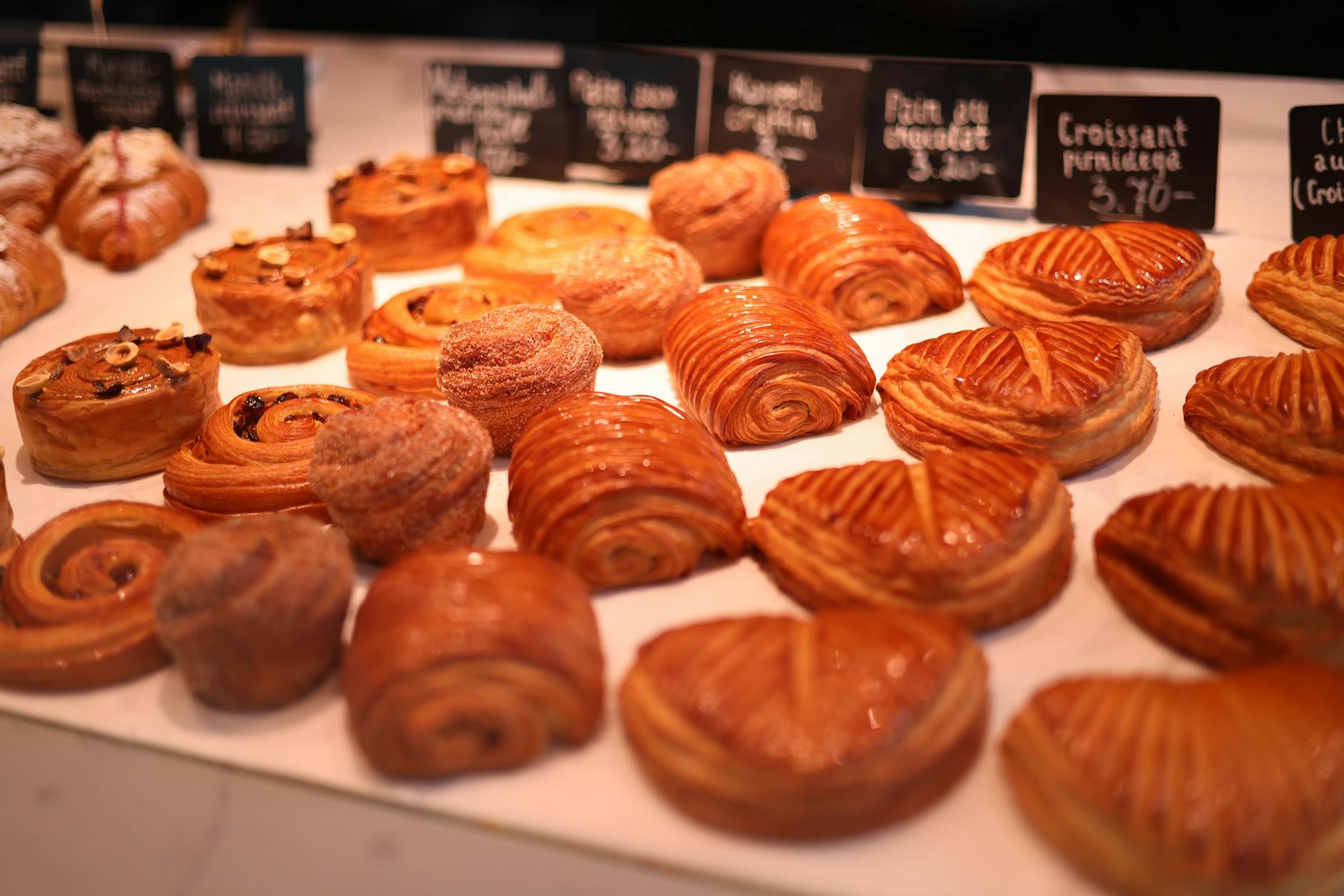 Bakery display case showing a variety of French pastries arranged carefully