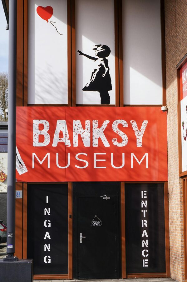 Entrance to a Banksy museum featuring the iconic girl with balloon artwork