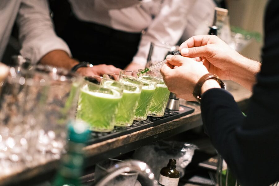 Bartender preparing green cocktails in Parisian bar
