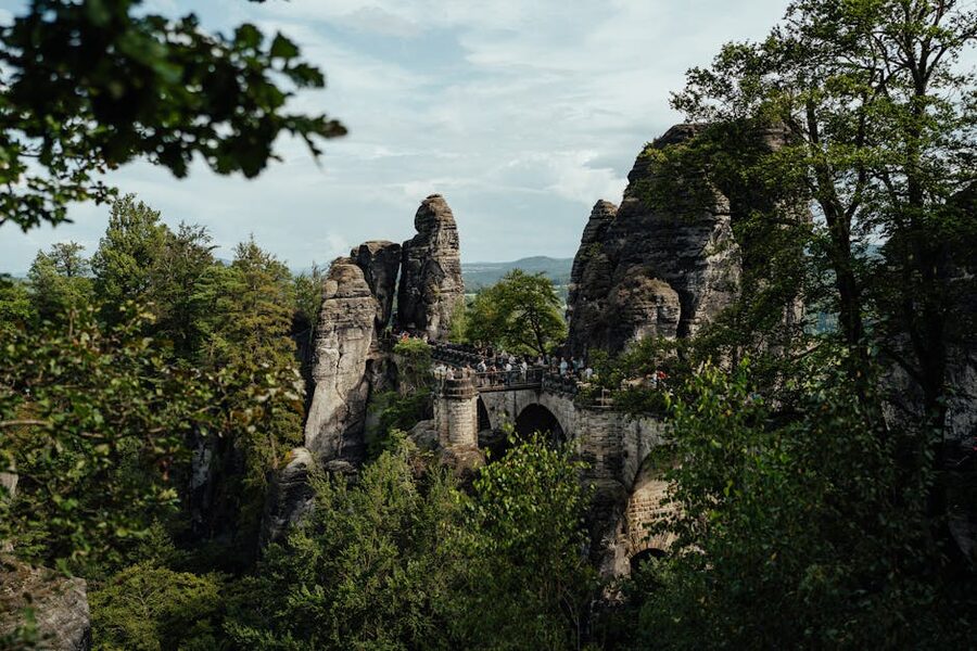 Bastei Bridge amidst lush greenery and rocky terrain
